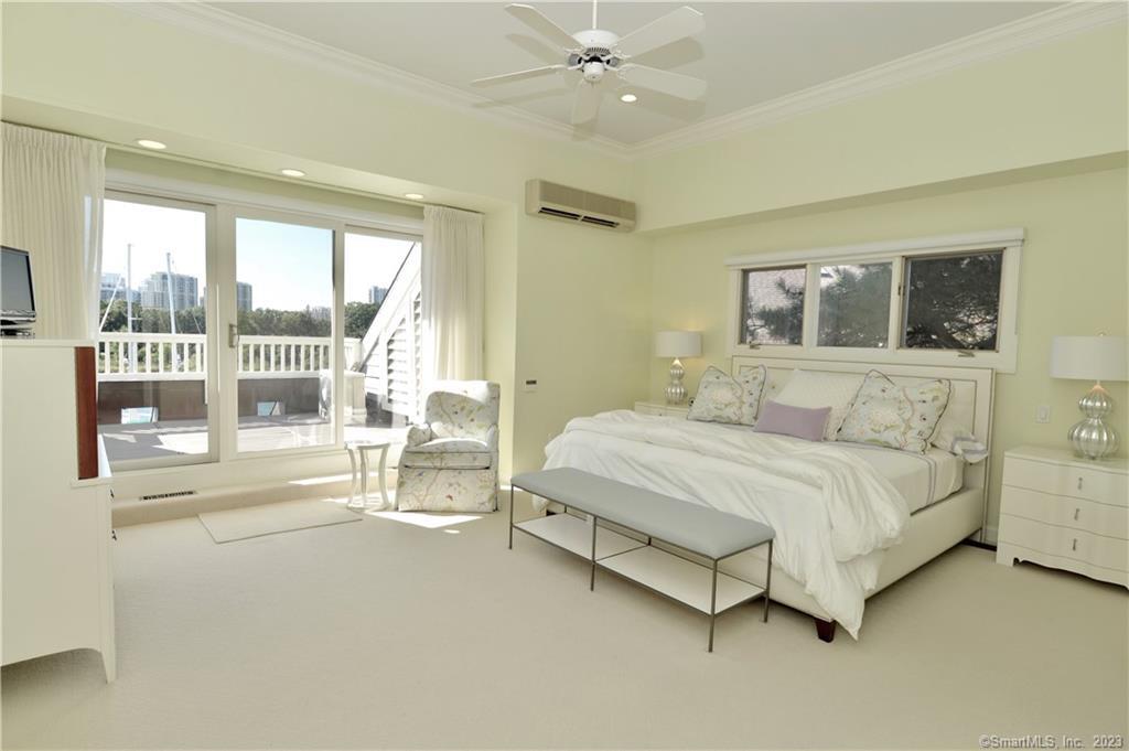 123 Harbor Drive, Unit 512 Stamford, CT 06902 - Photo 11 of 24 a spacious bedroom with a bed and a large window
