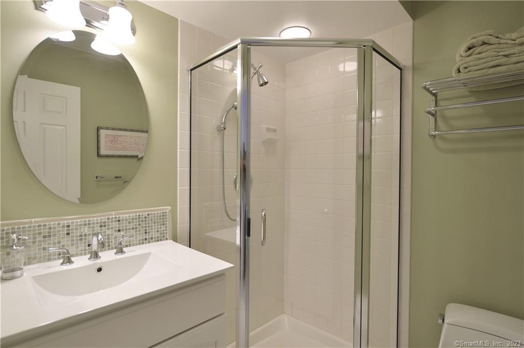 123 Harbor Drive, Unit 512 Stamford, CT 06902 - Photo 19 of 24 a bathroom with a sink and a mirror