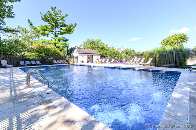 123 Harbor Drive, Unit 512 Stamford, CT 06902 - Photo 20 of 24 a view of a swimming pool with a patio