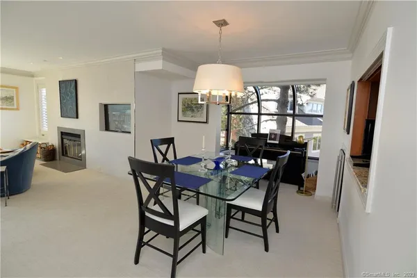 a view of a dining room with furniture and a chandelier