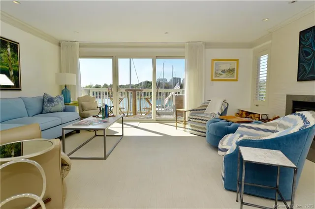 a living room with furniture and a floor to ceiling window