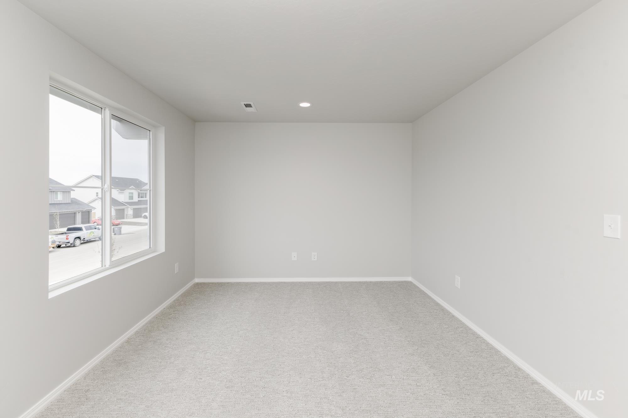 12842 Ropers Street Nampa, ID 83651 - Photo 15 of 29 Spacious room featuring light gray carpeting and white baseboards