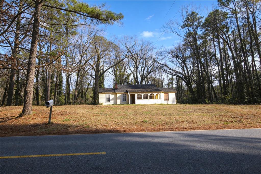 731 Bolton Road Northwest Atlanta, GA 30331 - Photo 2 of 20 a front view of a house with a yard and covered with snow