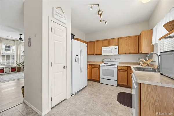 a kitchen with a refrigerator stove and sink