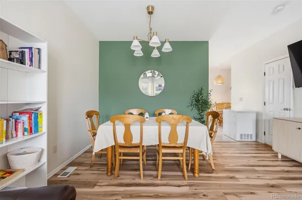 a view of a dining room with furniture and wooden floor