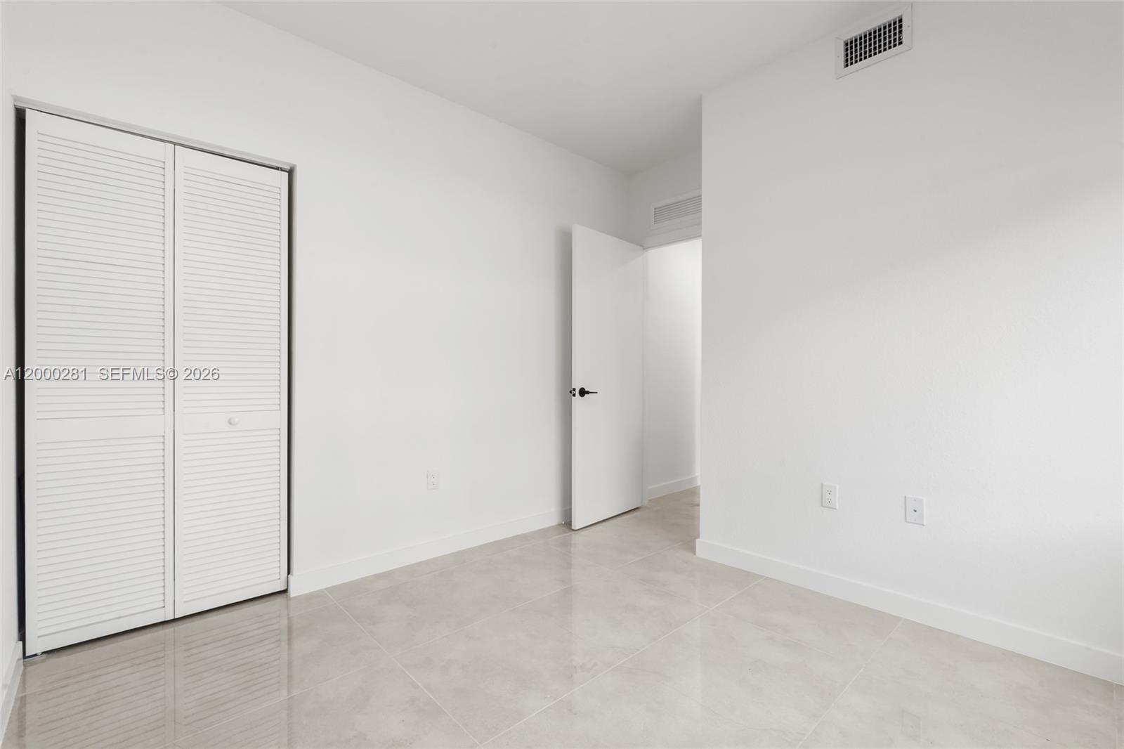 14513 Southwest 261st Street, Unit EFFICIENCY Homestead, FL 33032 - Photo 5 of 9 an empty room with closet area