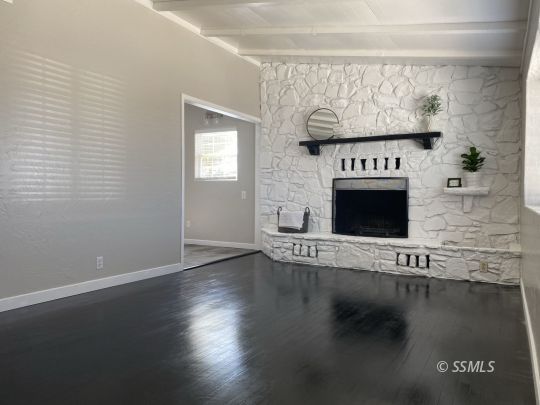 416 North Helena Street Ridgecrest, CA 93555 - Photo 5 of 22 a view of an empty room with wooden floor and a fireplace