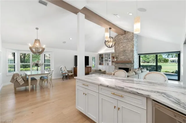 a view of dining table chairs and chandelier