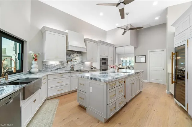a kitchen with stainless steel appliances granite countertop a lot of counter space and wooden floors