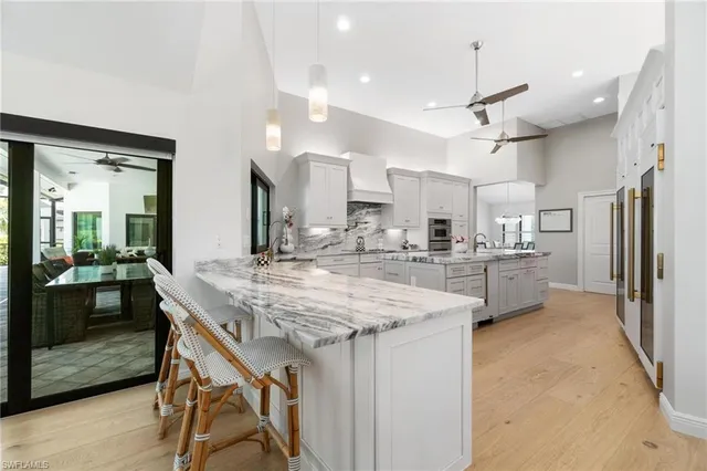 a kitchen with stainless steel appliances granite countertop counter space a sink refrigerator and cabinets