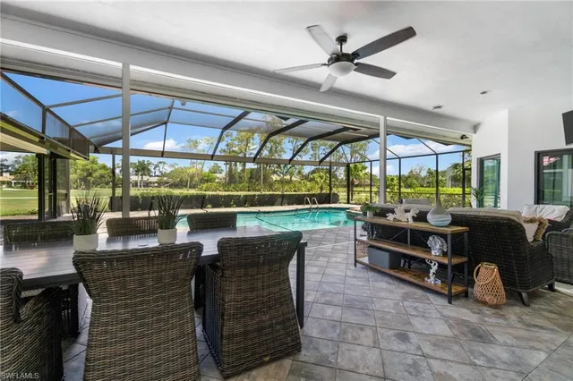 a view of a patio with table and chairs under an umbrella