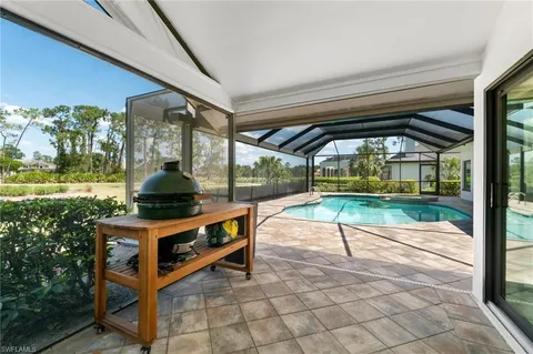 a view of backyard with a table and chairs in patio