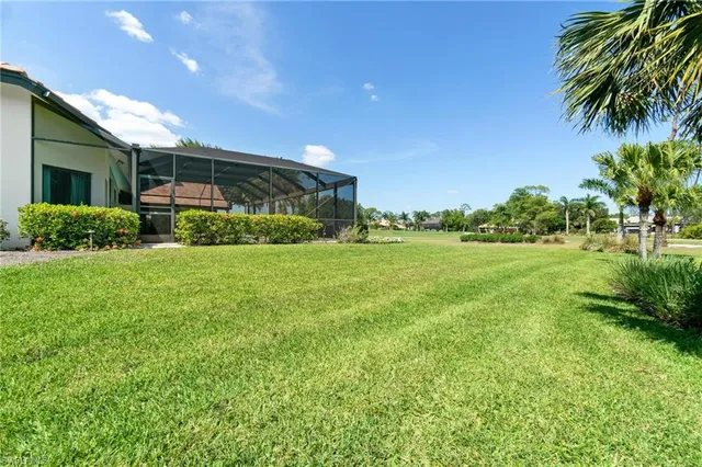 a view of a house with a big yard and potted plants
