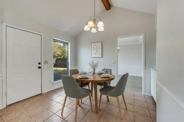 a view of a dining room with furniture and chandelier