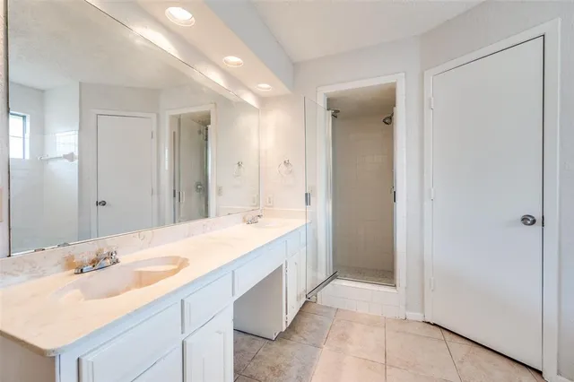 a spacious bathroom with a double vanity sink mirror and double