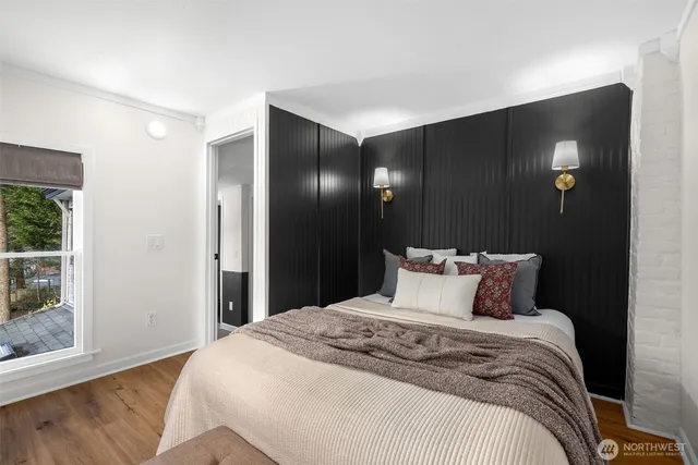 a bedroom with a large bed and a large mirror