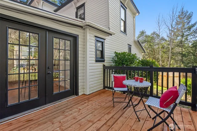 a patio with lawn chairs and wooden floor