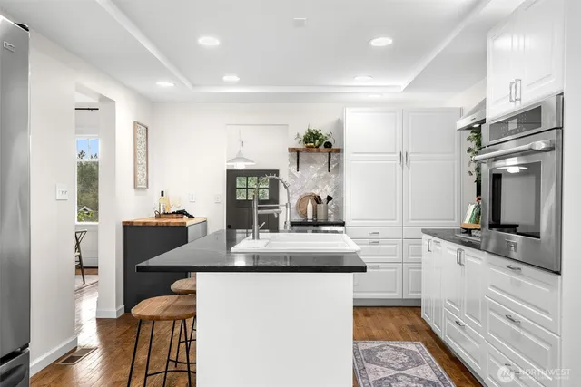 a kitchen with counter top space cabinets and stainless steel appliances