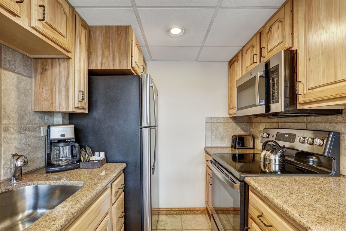 601 Village Road, Unit 503 Breckenridge, CO 80424 - Photo 11 of 48 a kitchen that has a sink and a stove