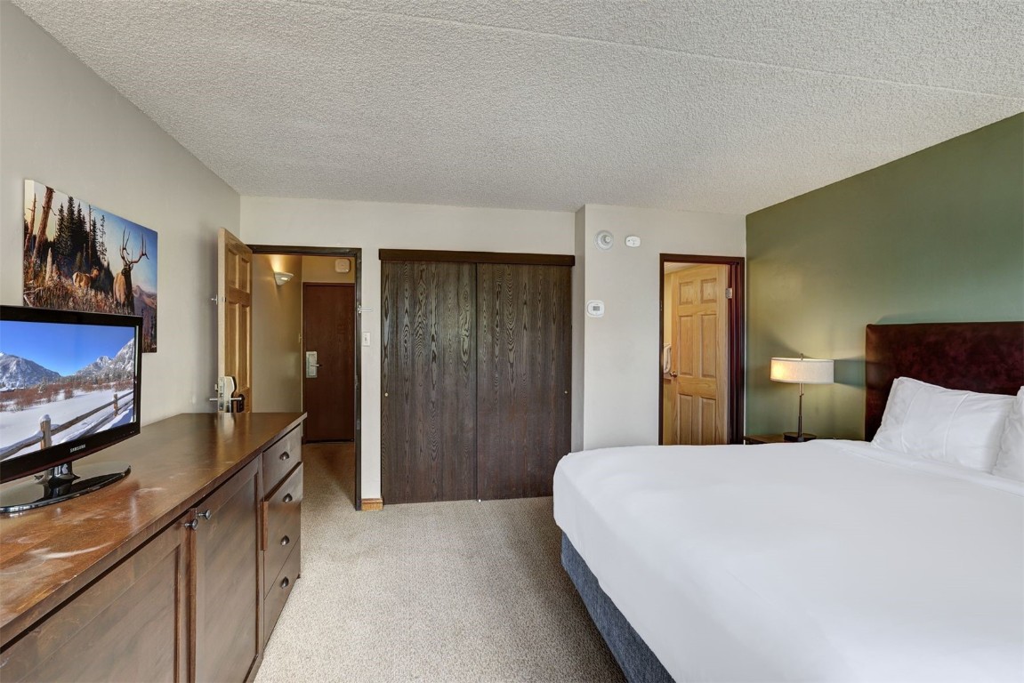 601 Village Road, Unit 503 Breckenridge, CO 80424 - Photo 16 of 48 a bedroom with a bed and a flat screen television