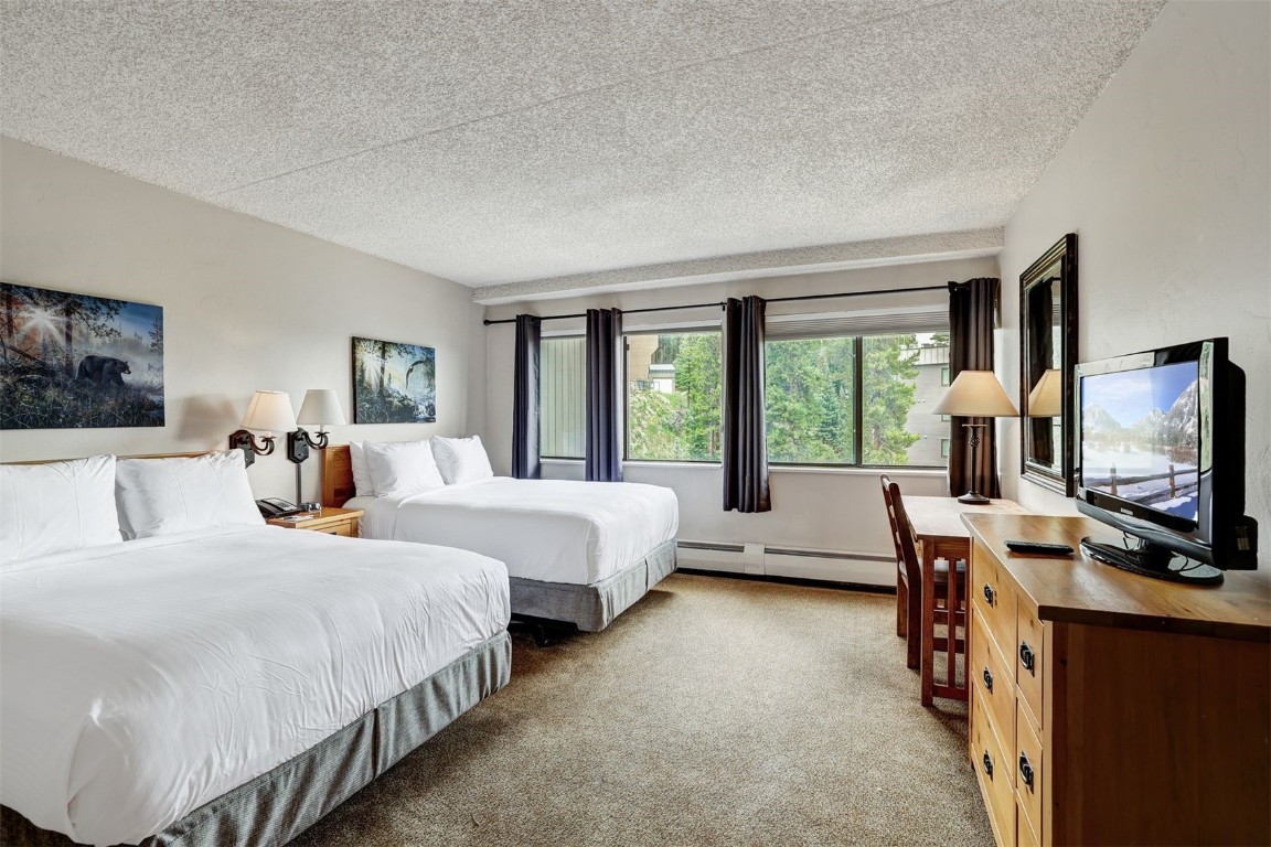 601 Village Road, Unit 503 Breckenridge, CO 80424 - Photo 20 of 48 a bedroom with bed a flat tv screen and a dresser