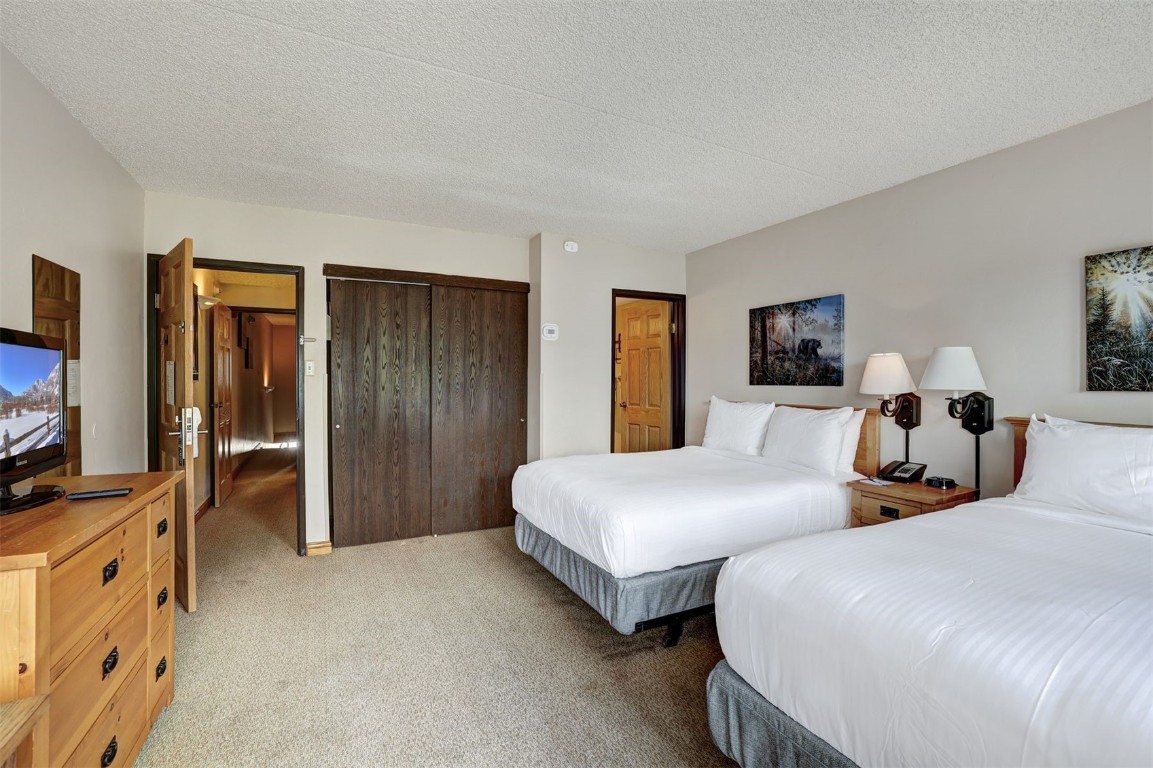601 Village Road, Unit 503 Breckenridge, CO 80424 - Photo 21 of 48 a bedroom with two beds and a flat tv screen