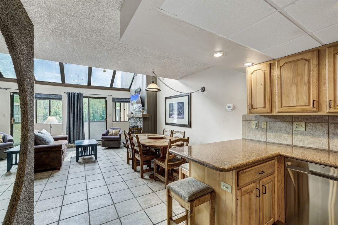 601 Village Road, Unit 503 Breckenridge, CO 80424 - Photo 7 of 48 a open kitchen with a sink dining table and chairs