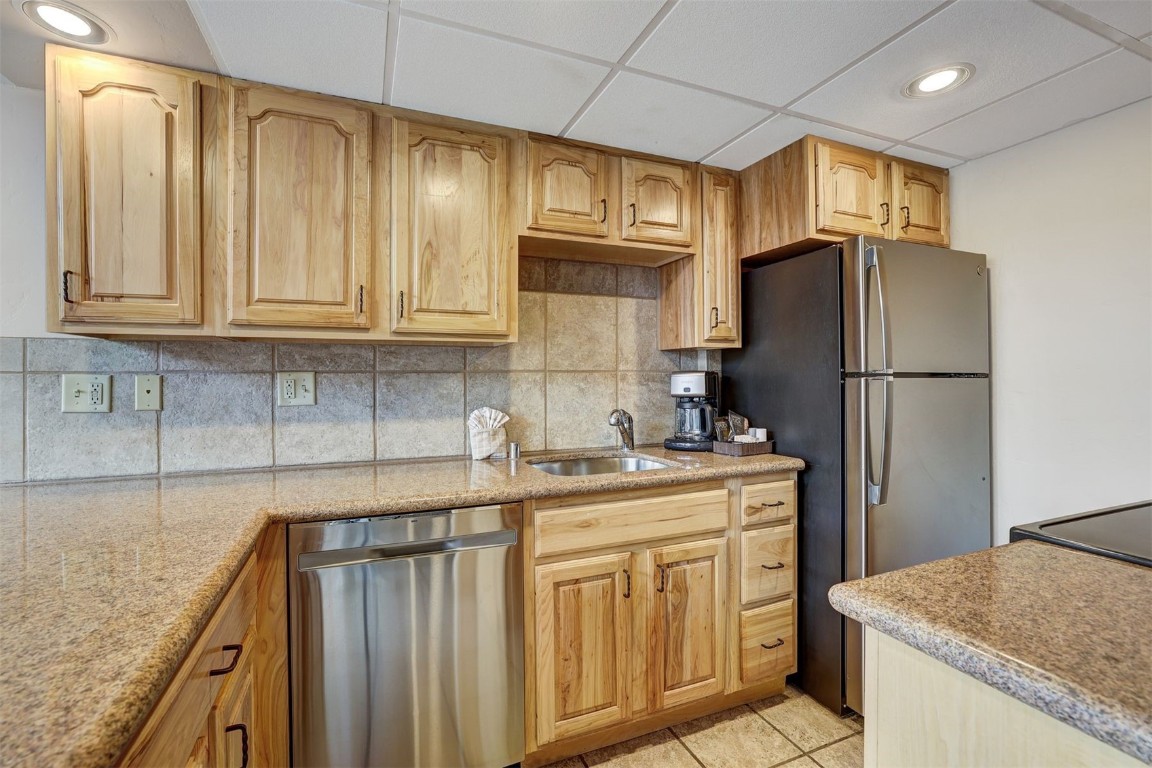 601 Village Road, Unit 503 Breckenridge, CO 80424 - Photo 8 of 48 a kitchen with kitchen island granite countertop cabinets and refrigerator