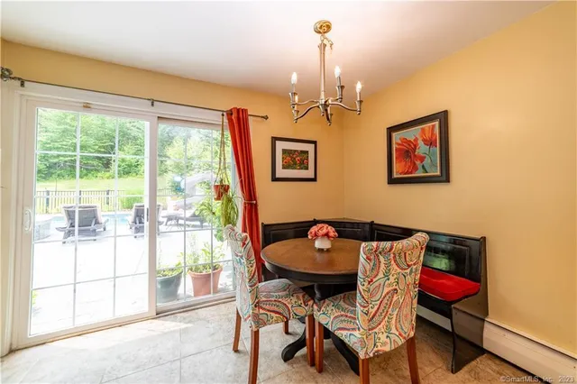 a view of a dining room with furniture and a window