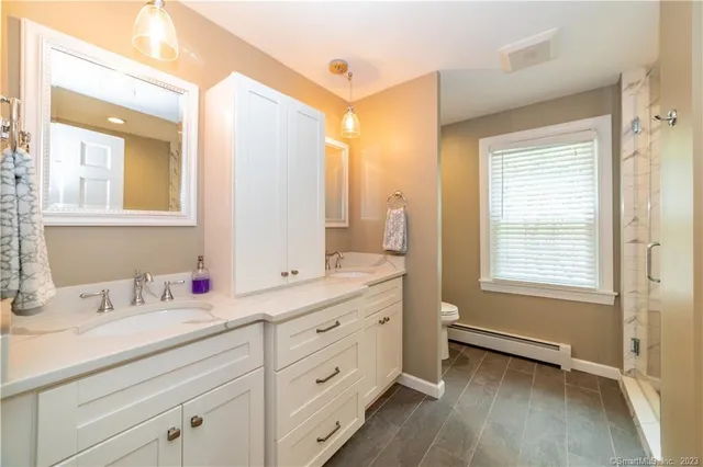 a bathroom with a double vanity sink a mirror and a