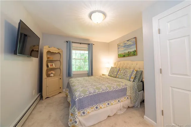 a bedroom with a bed and a tv