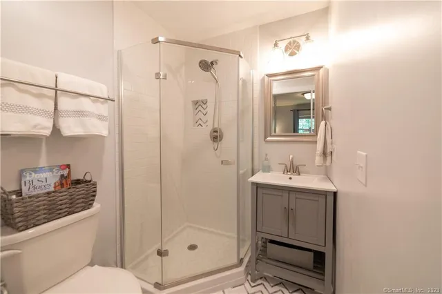 a bathroom with a shower a sink and a mirror