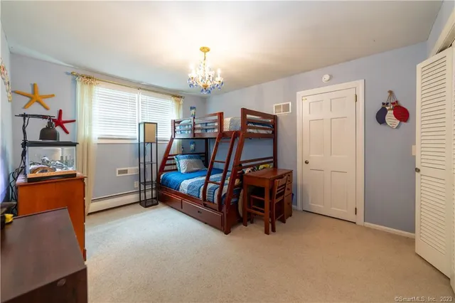 a bedroom with furniture and a window