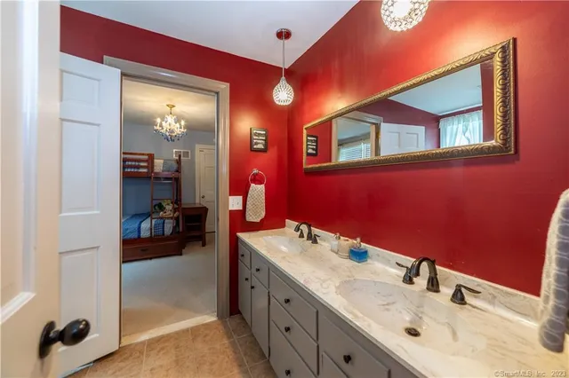 a en suite bathroom with a sink double vanity and a mirror
