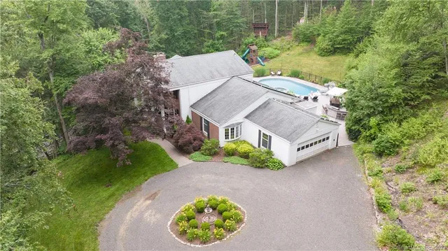 an aerial view of a house with a garden and a yard