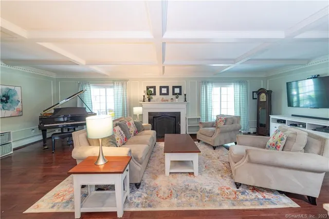 a living room with furniture a fireplace and a flat screen tv