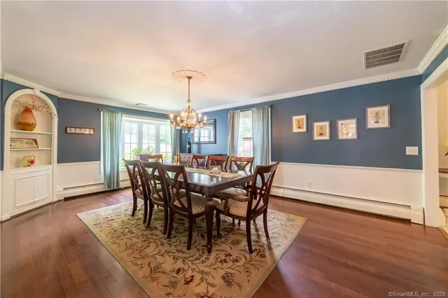 a view of a dining room with furniture and wooden floor
