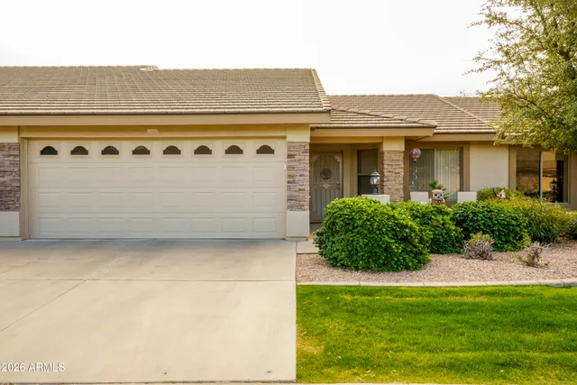 a front view of a house with a yard and garage