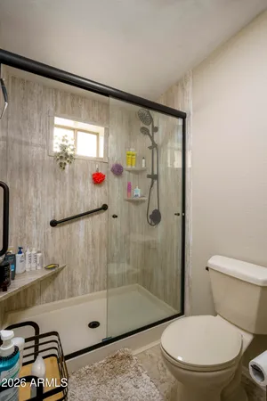 a bathroom with a toilet and a shower