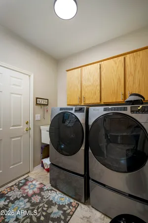 a utility room with sink dryer and washer