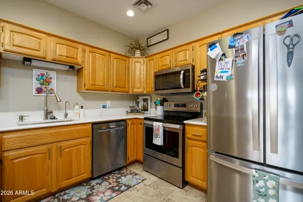 a kitchen with stainless steel appliances granite countertop a refrigerator sink and microwave