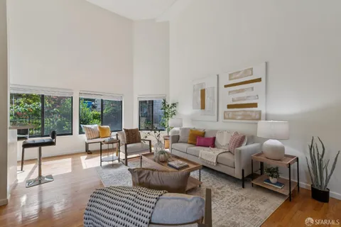 a dining room with furniture and wooden floor