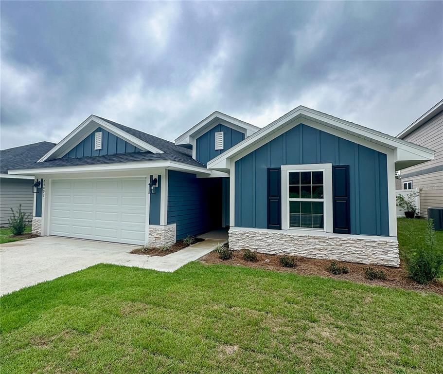 25093 Southwest 23rd Road Newberry, FL 32669 - Photo 1 of 1 a front view of a house with a yard and garage