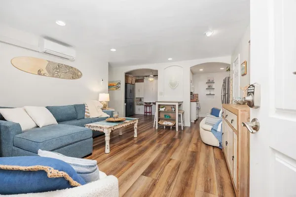 a living room with furniture and a wooden floor