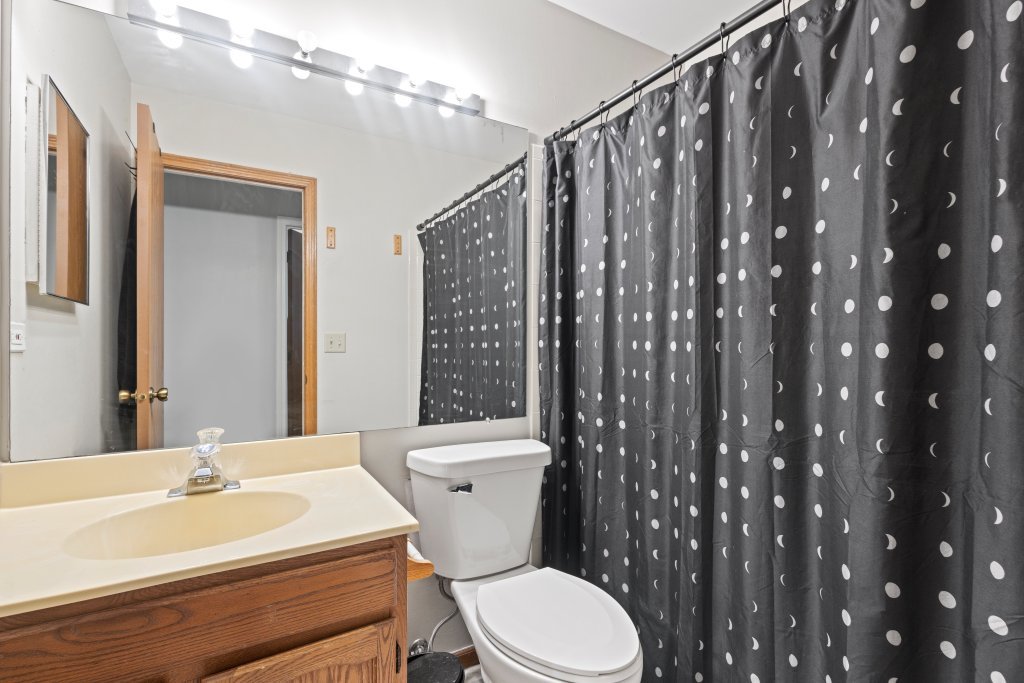 798 Burning Trail Carol Stream, IL 60188 - Photo 11 of 40 a bathroom with a sink a toilet a mirror and shower curtain