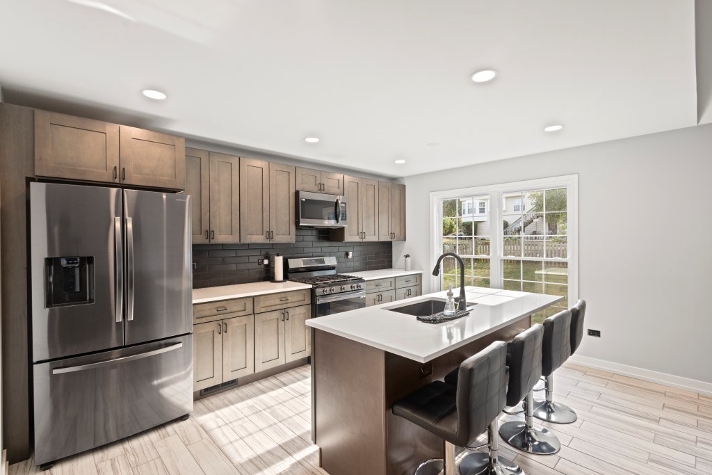 798 Burning Trail Carol Stream, IL 60188 - Photo 2 of 40 a kitchen with stainless steel appliances granite countertop a refrigerator a sink dishwasher a stove and a refrigerator with wooden floor