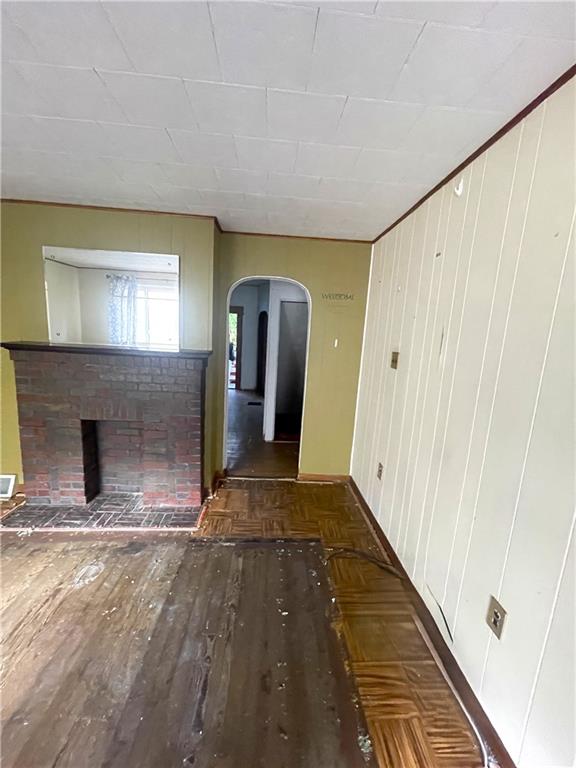 323 Hancock Street Pittsburgh, PA 15219 - Photo 5 of 41 a view of a hallway with wooden floor and a fireplace