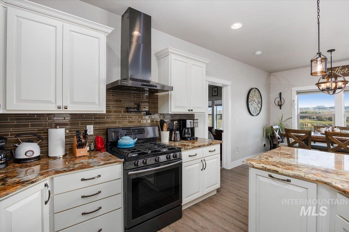 40 Bell Rapids Road Hagerman, ID 83332 - Photo 12 of 50 Kitchen featuring stainless steel range with gas cooktop, dark stone counters, and white cabinets