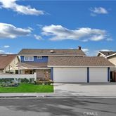 a front view of a house with a garden and plants