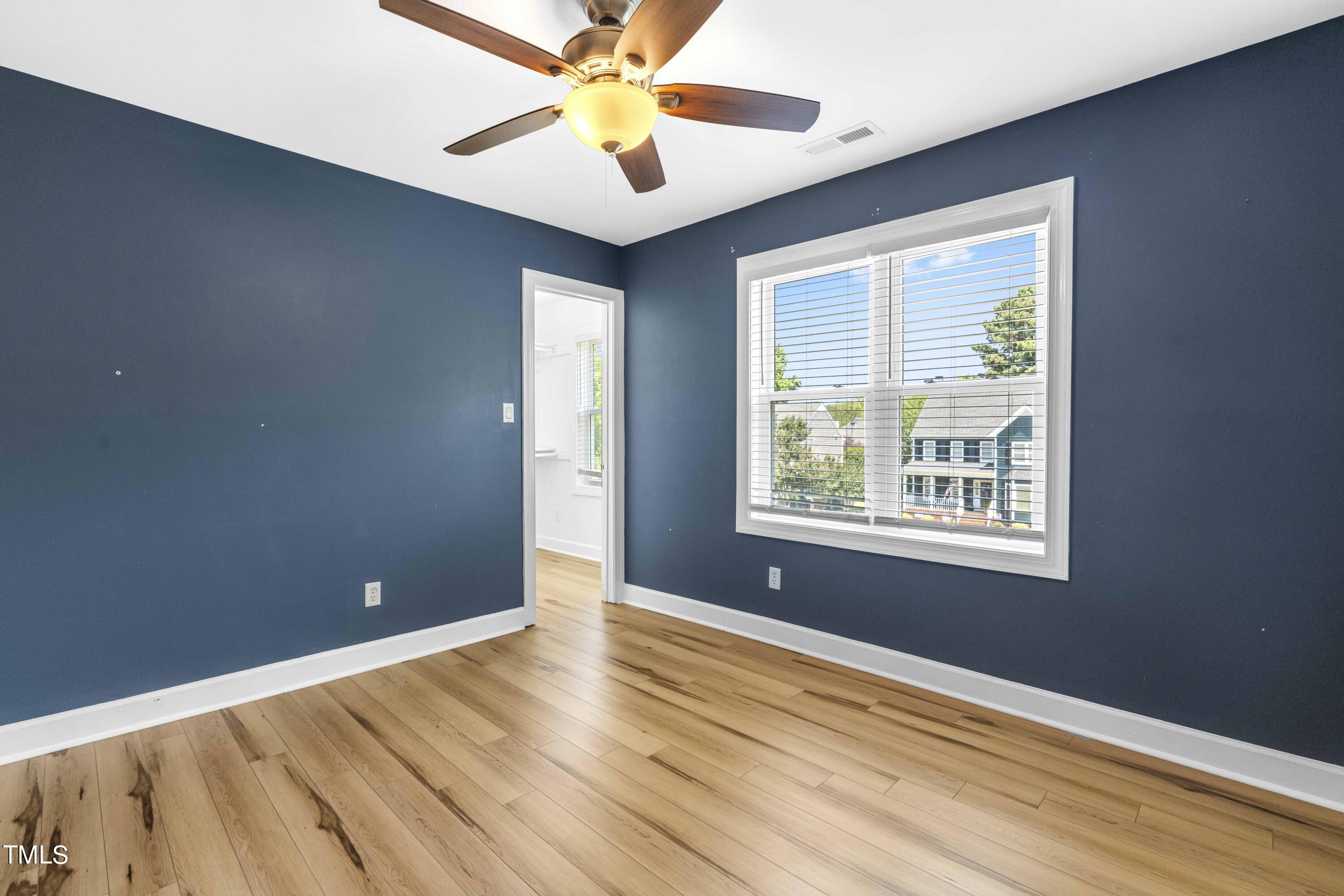1206 Rainesview Lane Apex, NC 27502 - Photo 19 of 26 a view of an empty room with window and wooden floor
